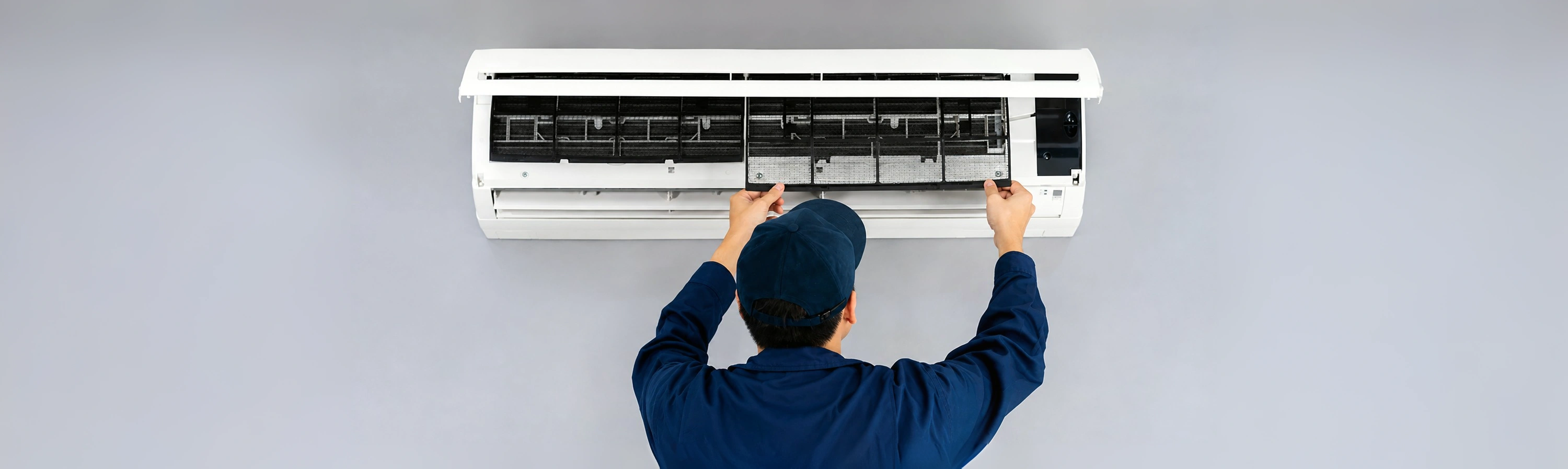 Technician servicing an air conditioning unit